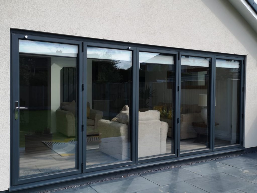 Wide aluminium glazed run on a white rendered rear elevation