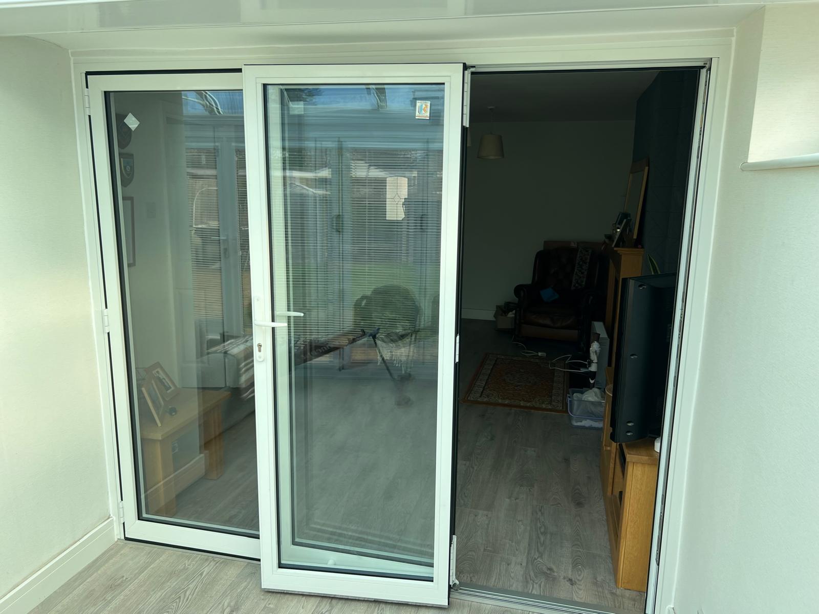 White framed doors opening from a living space