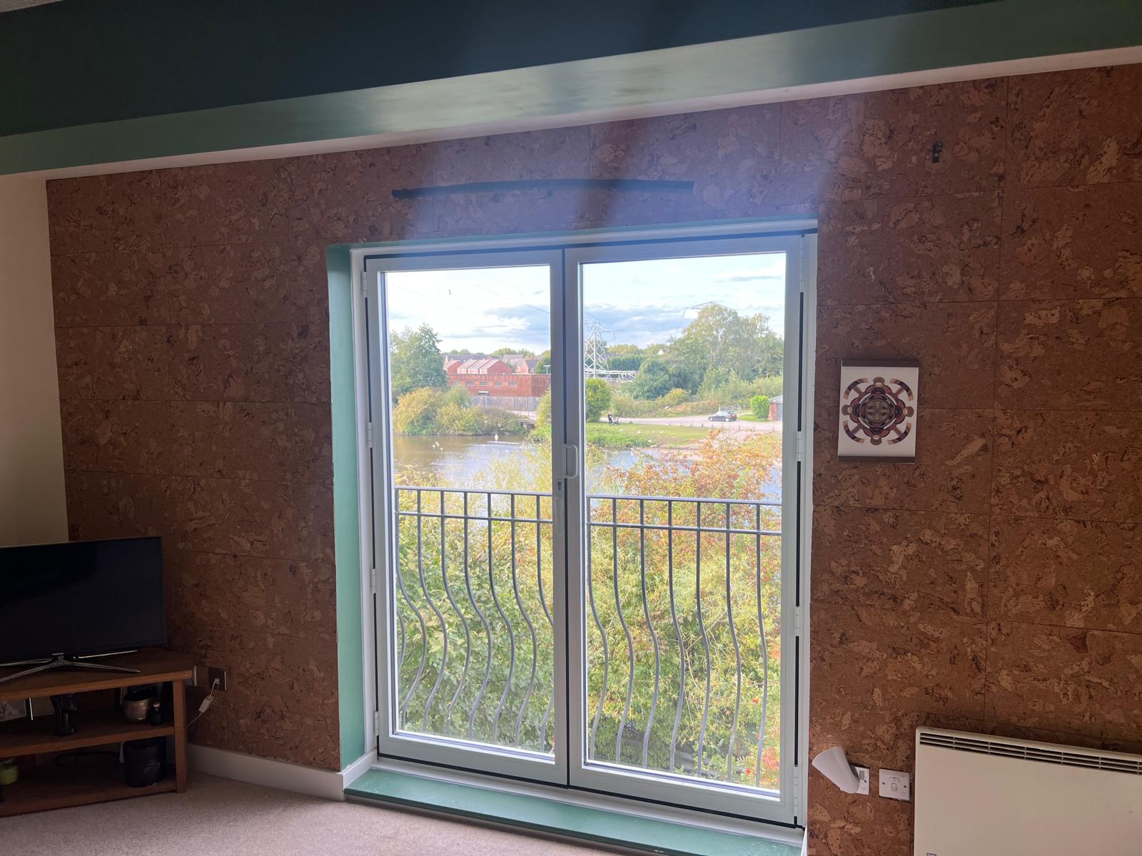 White framed sliding patio doors overlooking open water