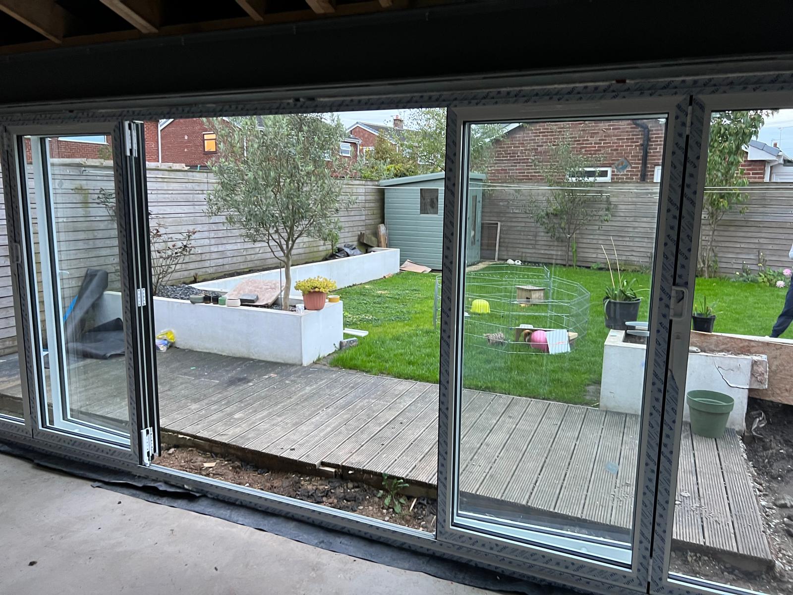 Dark grey glazed doors looking out over a garden