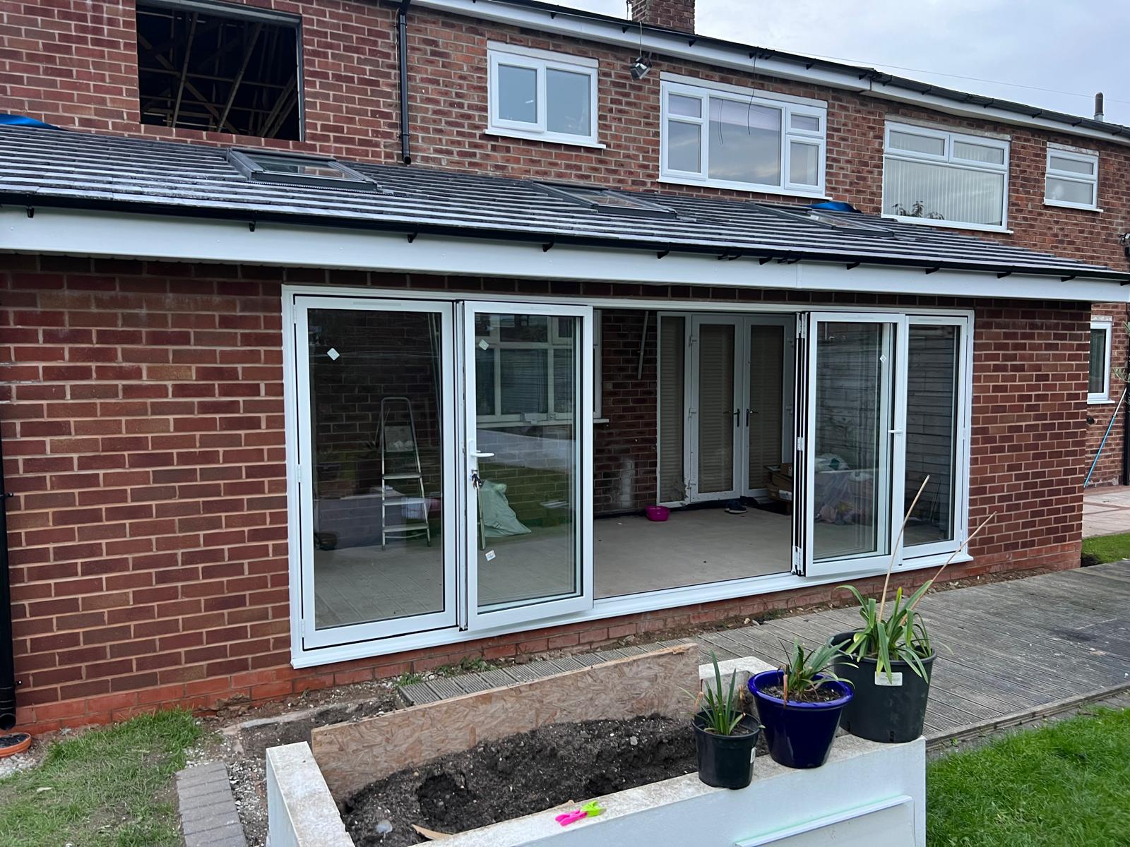 White and grey framed windows on a brick rear elevation