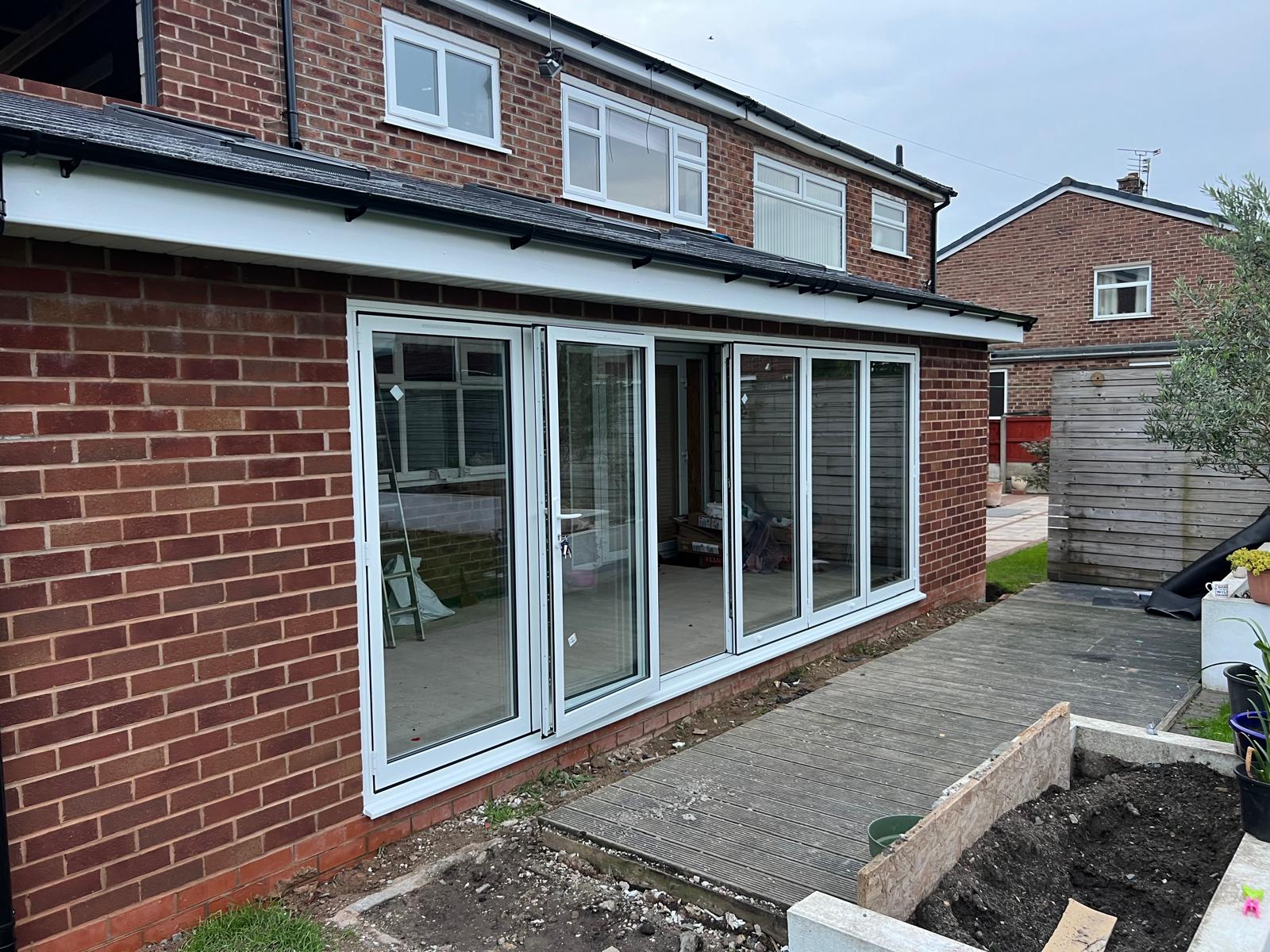 Windows and doors fitted to a red brick rear elevation